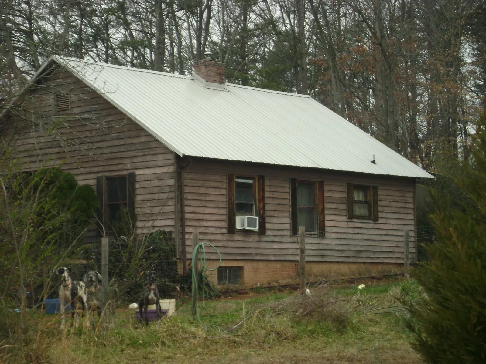 White metal roof on an old wood sided farmhouse, from a Metal Roof Installation job in Taberg